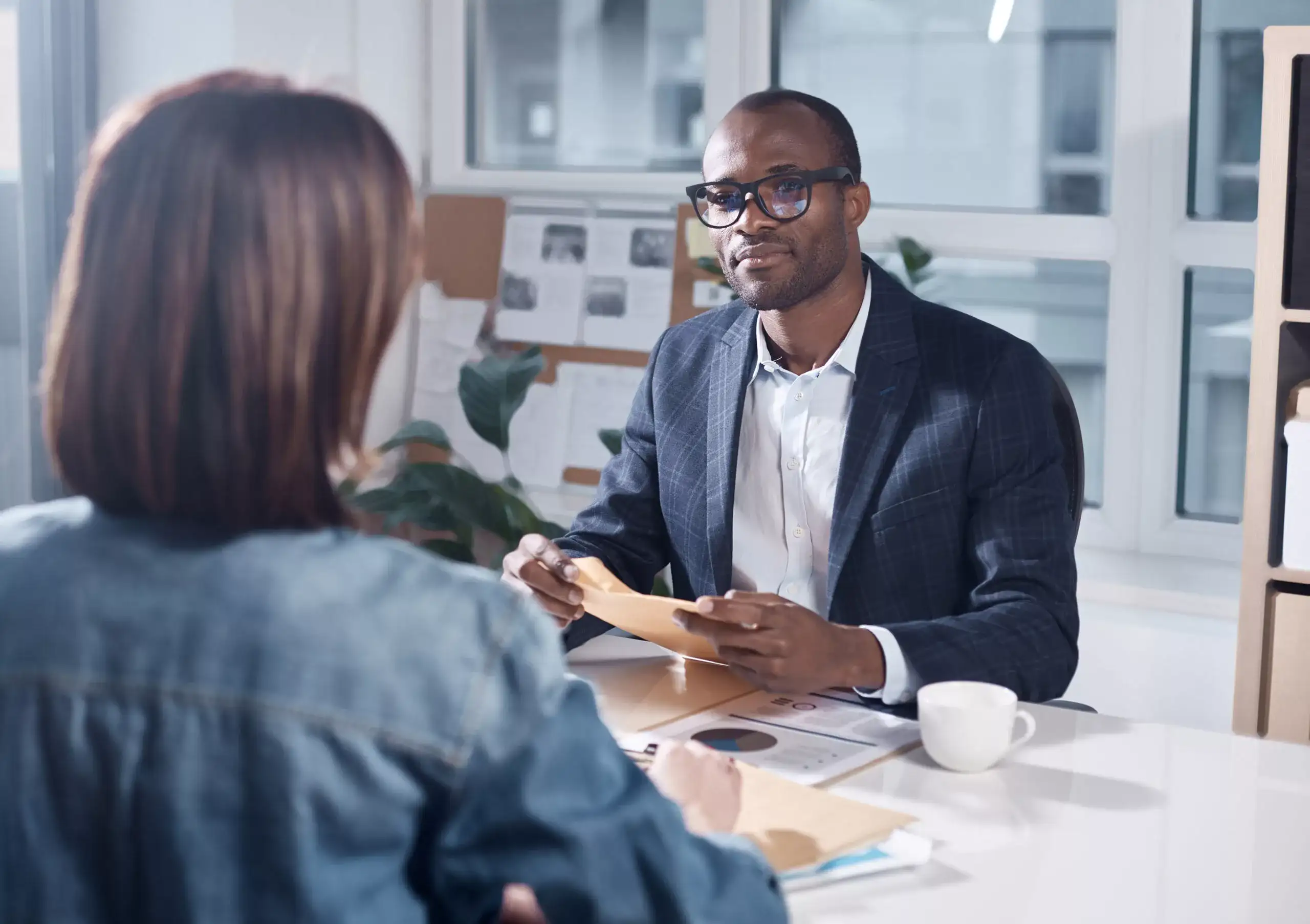 Interview between man and a woman in an office setting