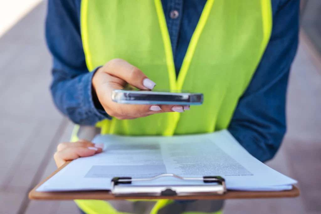 Worker on a phone looking at a clipboard