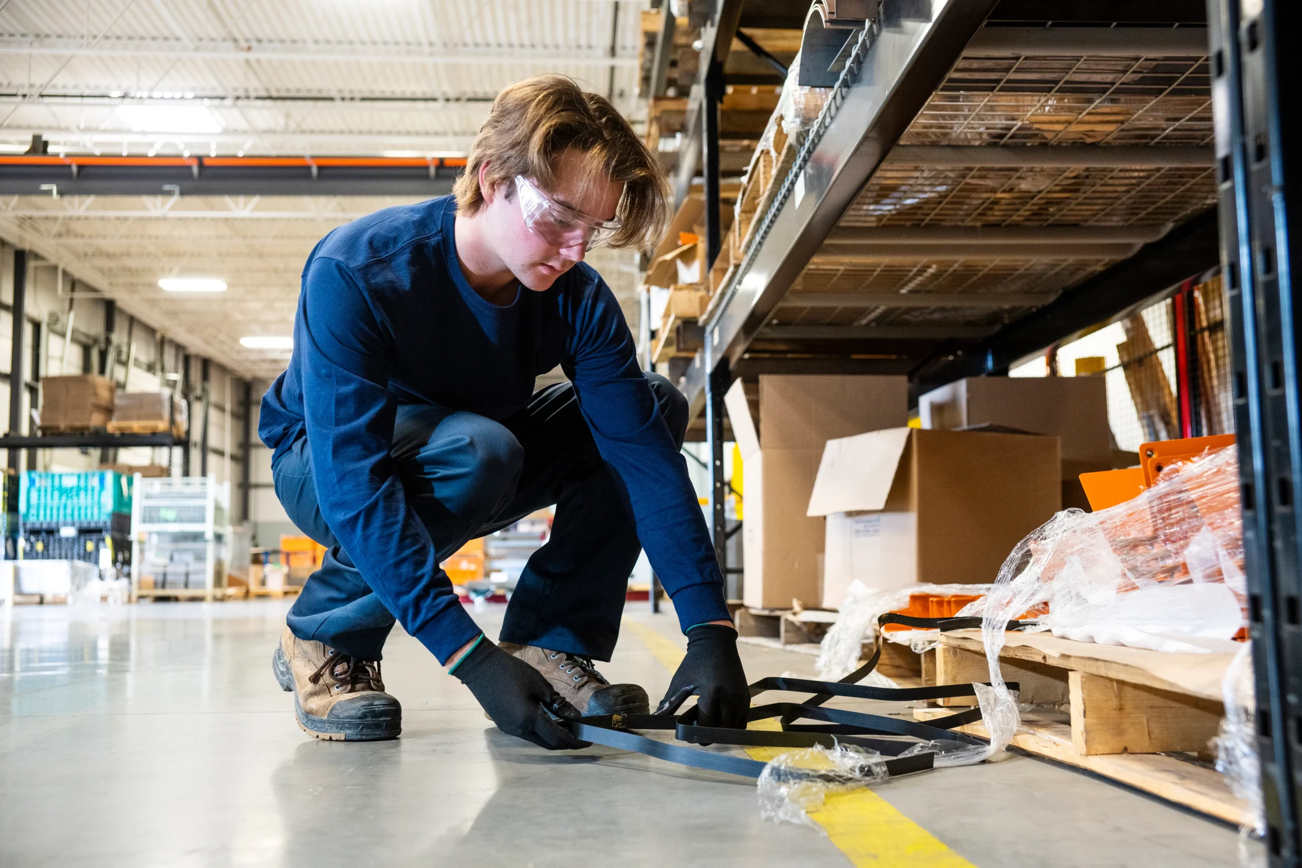 A man investigating in a warehouse