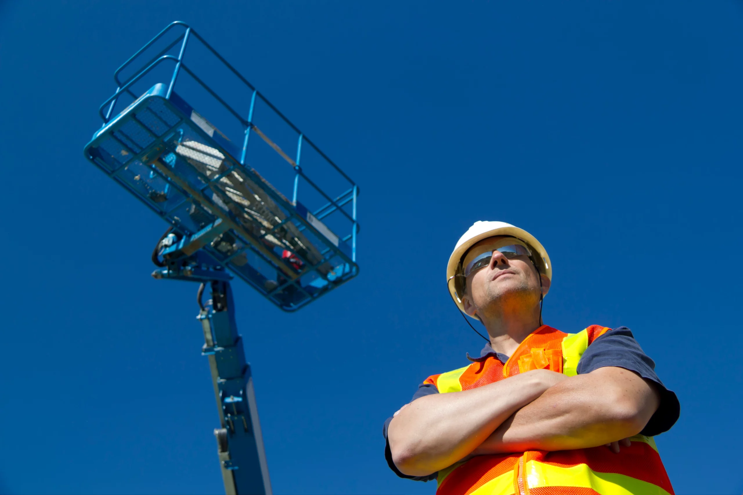 Lifting operations worker next to lifting equipment